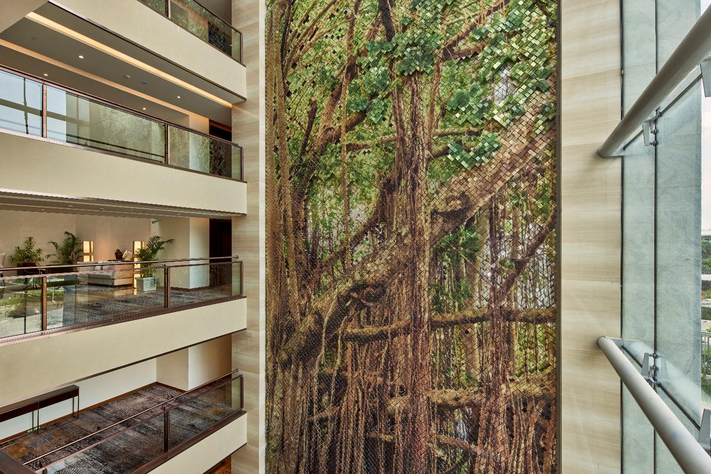 A striking mosaic of a banyan tree anchors the atrium, weaving nature into the fabric of the built environment.